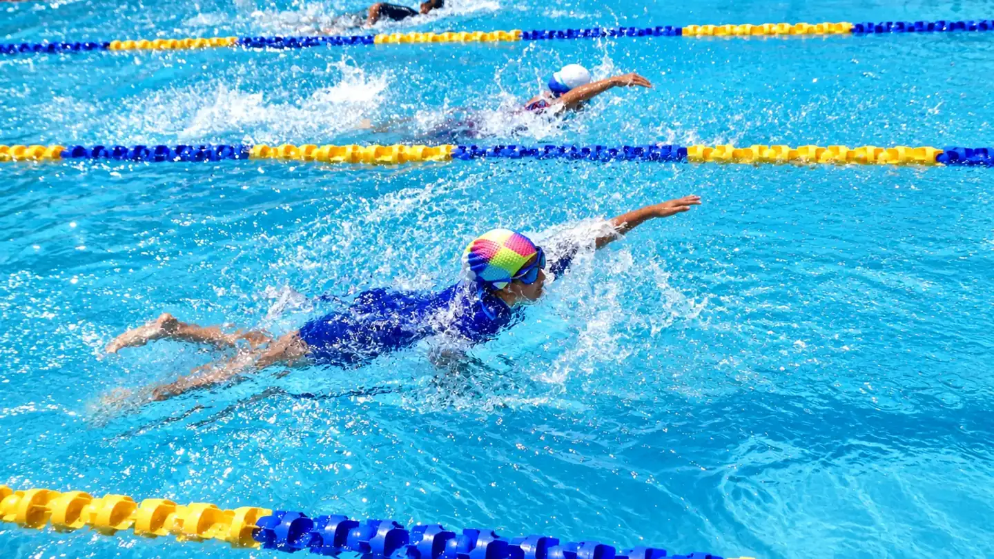 Student swimming freestyle in the DPS Chhindwara swimming pool