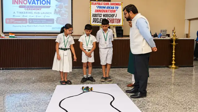 Students demonstrating a line-follower robot at Delhi Public School Chhindwara