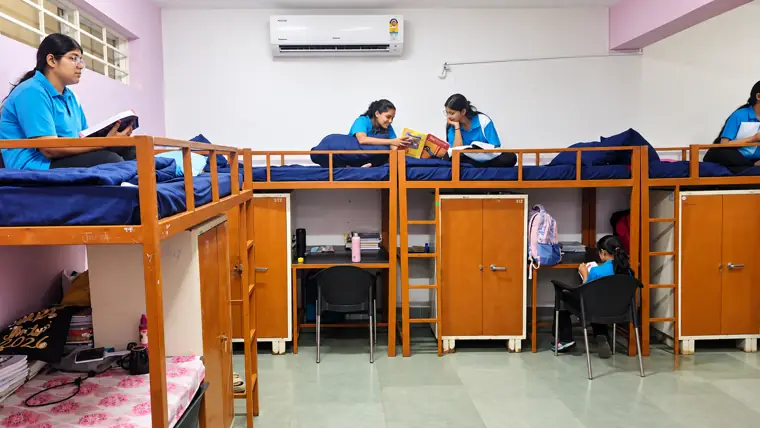 Girls' hostel room with study desks and cupboards at DPS Chhindwara