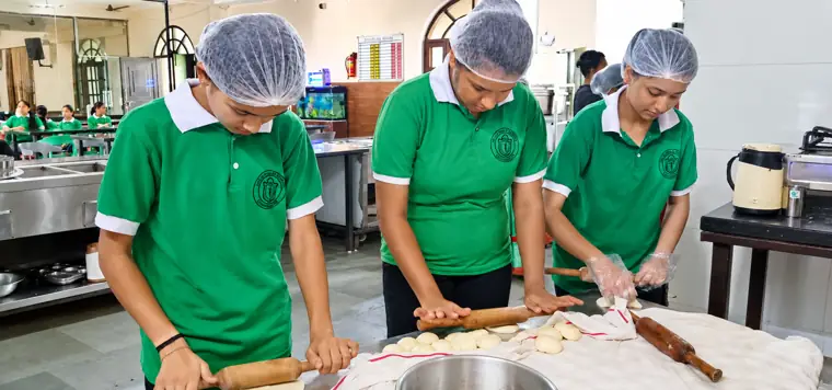 Students rolling dough at a hostel cooking workshop at DPS Chhindwara